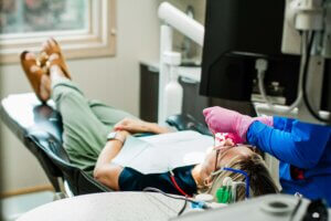 A woman recieving treatment in Fargo while under dental sedation.