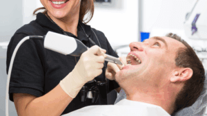 A young man having his mouth prepared for CEREC dental crowns in Fargo.