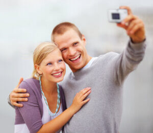 A young couple smiling, free of dental anxiety thanks to sedation in Fargo.
